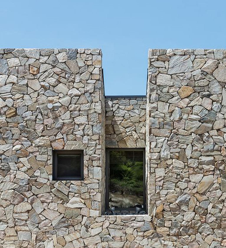 Contemporary villa facade in hand-cut natural stone